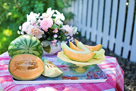 sliced melon and watermelon fruits on beige tray thumbnail