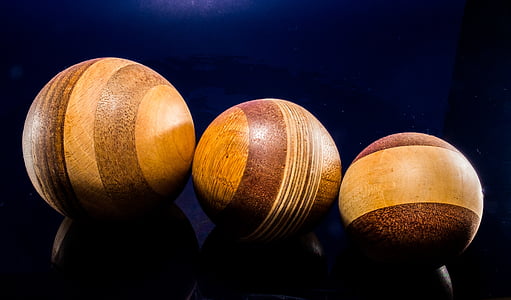 three brown balls on black background thumbnail
