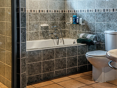 white ceramic toilet bowl with cistern and bathtub thumbnail