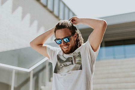 man wearing white t-shirt and black wayfarer-style sunglasses thumbnail