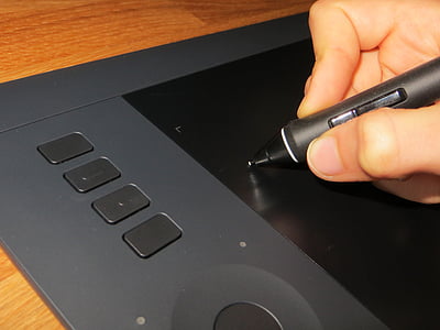person using stylus pen on black drawing tablet thumbnail