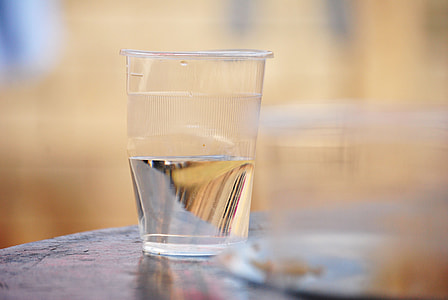 selective focus photography of half empty disposable cup thumbnail