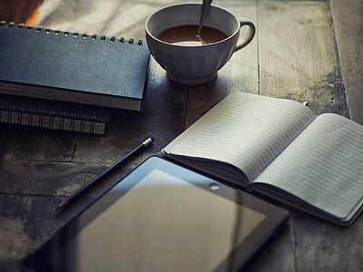white ceramic mug beside open notebook thumbnail