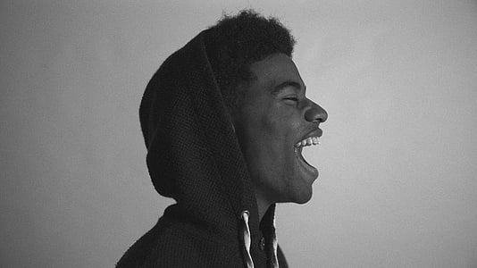 grayscale photo of man with hoodie thumbnail