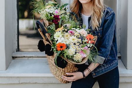 Young woman with basket full of flowers thumbnail