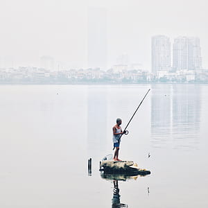 man fishing on sea thumbnail