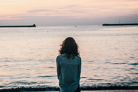 woman sitting near seashore thumbnail