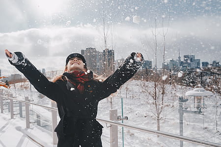 Laughing Woman In Snowy Urban Park Photo thumbnail