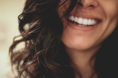 half face photo o f smiling woman thumbnail