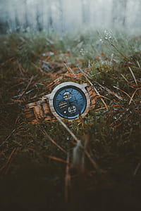 round blue chronograph watch on grass field thumbnail