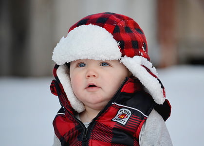 shallow focus photography of baby in red and black jacket thumbnail