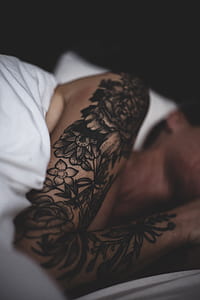 person with black floral right shoulder tattoo thumbnail