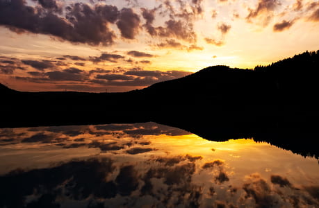 silhouette of mountains under gray clouds thumbnail