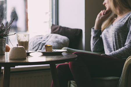 woman sitting on sofa chair at table thumbnail