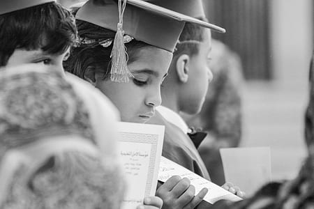 selective focus photo of boy wearing mortar board standing in line thumbnail