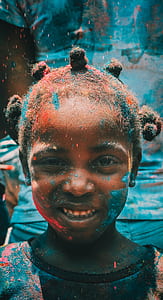 girl covered with blue paint on her face thumbnail
