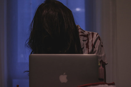 woman in brown and white top near silver MacBook thumbnail