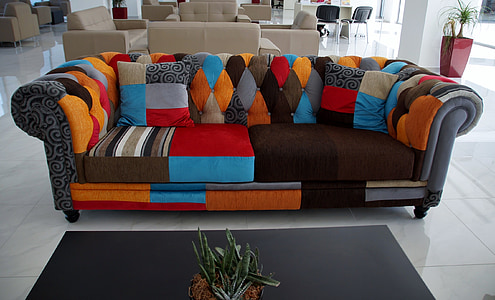 photo of empty tufted gray and multicolored roll-arm sofa thumbnail