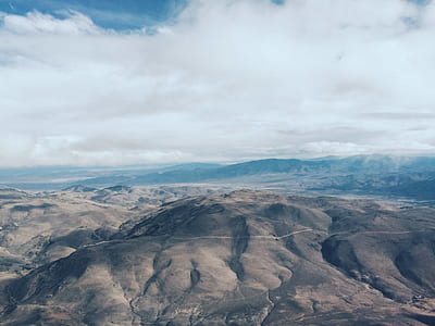 brown plateau mountain under white and blue sky at daytime thumbnail