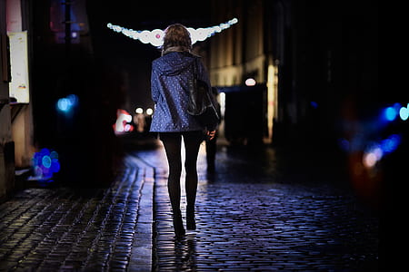 woman walking on street at night thumbnail