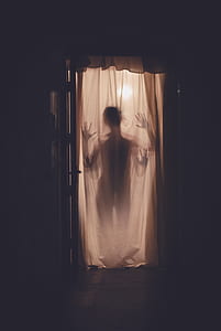 person standing behind curtain thumbnail