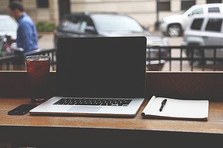 MacBook pro beside notebook and pen thumbnail