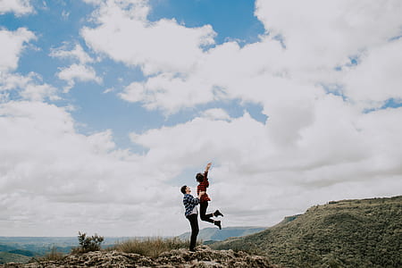 woman and man doing jump shot on hill thumbnail
