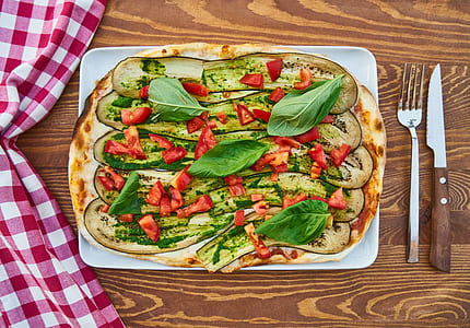 flat lay photography of baked pizza on white tray thumbnail