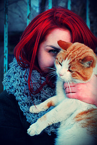 woman carrying yellow tabby cat thumbnail