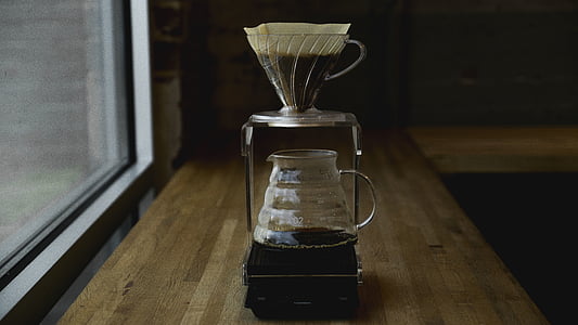 gray pitcher with coffee beside window thumbnail