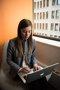 Photo of Woman Sitting on Chair and Typing on Silver Macbook thumbnail