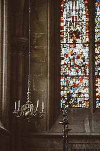 gray uplight chandelier in front of mosaic window thumbnail
