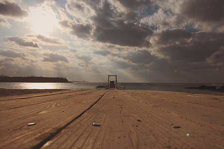 close up photography of brown wooden table through beach thumbnail