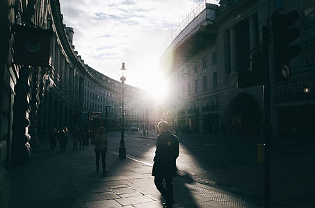 man standing near black post during daytime thumbnail
