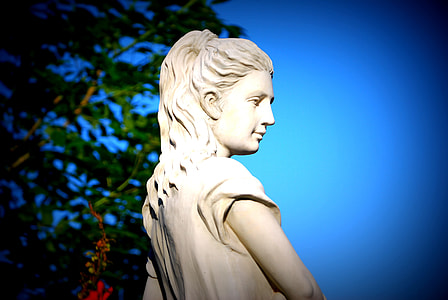 woman concrete statue near tree thumbnail