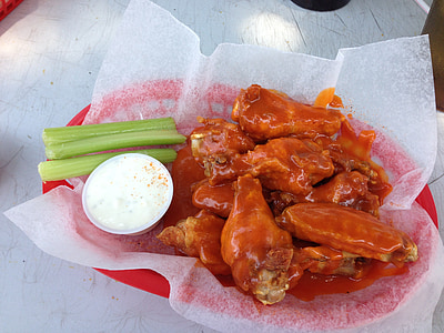 cooked chicken covered with red sauce and celery side dish with white sauce dip thumbnail