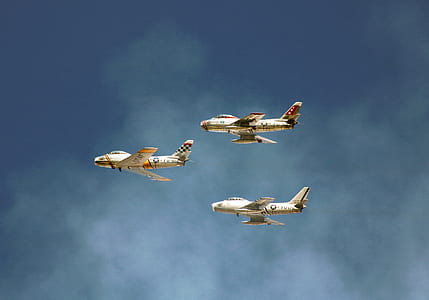 panning photography of three flying white planes thumbnail