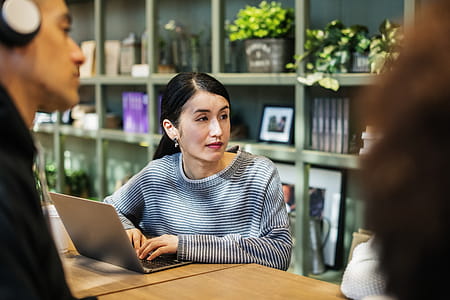 Woman Operating Laptop on Table thumbnail