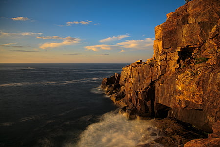 rock formation beside ocean during daytime thumbnail