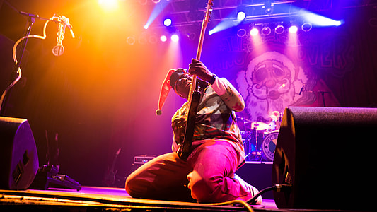 man playing guitar on stage thumbnail