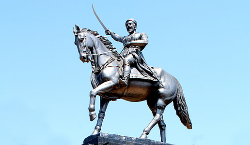 man riding horse while holding sword statue thumbnail