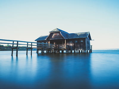 Brown Wooden House on Body of Water With Dock thumbnail