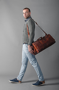 man wearing brown leather duffel bag thumbnail