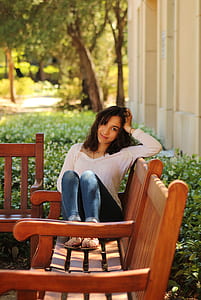woman sitting on bench while smiling thumbnail