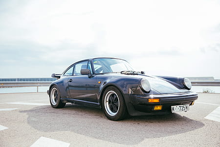 Side view of a black sports car with single door thumbnail