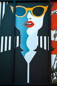 woman wearing yellow framed sunglasses with black garment artwork thumbnail