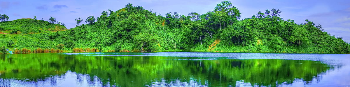 mountain reflection on body of water thumbnail