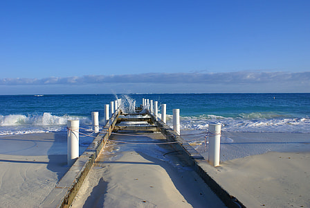 white and gray concrete boat dock under clear blue sky during daytime thumbnail