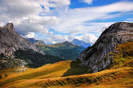 mountain range under white clouds and blue sky thumbnail