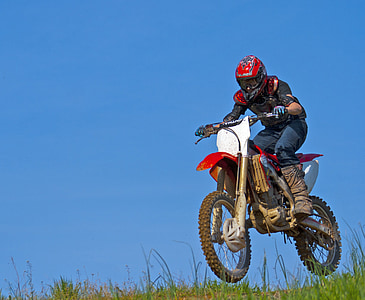person riding motocross dirt bike during daytime thumbnail